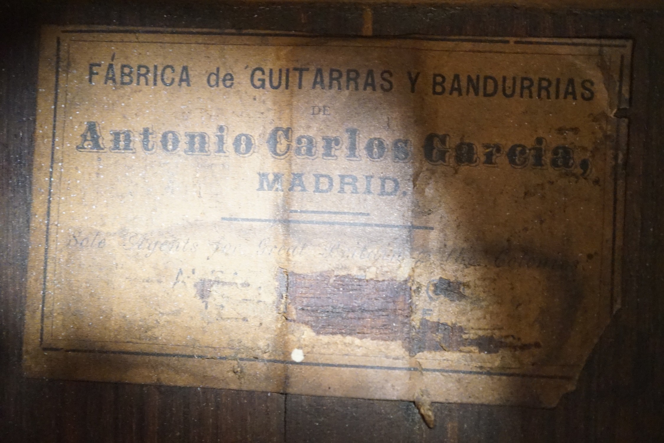 A 19th century Spanish parlour guitar labelled Antonio Carlos Garcia, Madrid. The back 46.5cm excluding button. Lacking strings, with soft case